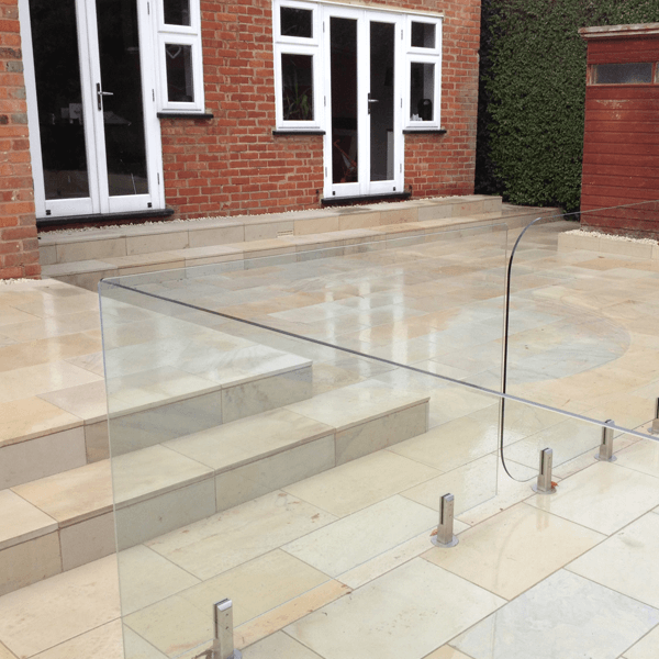 Sawn honed mint slabs with Glass Balustrade patio area in romford havering