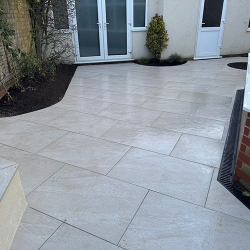 Porcelain patio with planting areas, new lawn and block paving in Chigwell Essex